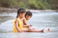 Two cute asian little child girls sitting and playing with sand Royalty Free Stock Photo