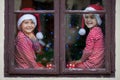 Two cute boys, brothers, looking through a window, waiting for S Royalty Free Stock Photo