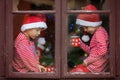 Two cute boys, brothers, looking through a window, waiting for S Royalty Free Stock Photo