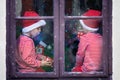 Two cute boys, brothers, looking through a window, waiting for S Royalty Free Stock Photo