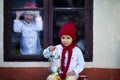 Two cute boys, brothers, looking through a window, waiting for S Royalty Free Stock Photo