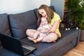 Two cute caucasian sisters of different age chatting online using laptop for video call. Royalty Free Stock Photo