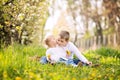 Two cute caucasian small kids, boy and girl, sitting in a grass Royalty Free Stock Photo