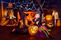 Two cute funny sisters celebrate the holiday. Jolly children in carnival costumes ready for Halloween.