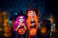 Two cute funny sisters celebrate the holiday. Jolly children in carnival costumes ready for Halloween. Royalty Free Stock Photo