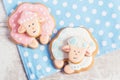 Two cute gingerbread sheep on blue polka dot background