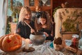 Two cute girls aged 10 years in witch costumes in an old house on Halloween brew a magic potion and conjure.