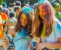 Two cute girls celebrate Indian holi festival with colorful pain