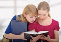 Two cute girls college reading book Royalty Free Stock Photo