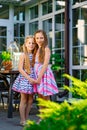 Two cute girls hugging in back garden of house Royalty Free Stock Photo