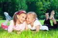 Two cute girls laughing on the grass Royalty Free Stock Photo