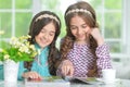 Portrait of two cute girls reading magazine Royalty Free Stock Photo