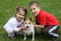 Two cute happy kids with dog Royalty Free Stock Photo