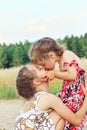 Two Cute happy little girls is smiling and hugging on summer filed