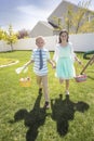 Two cute kids enjoying an Easter Egg Hunt Outdoors