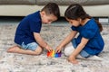 Two cute kids playing with flexible toy the Pop It fidget. Royalty Free Stock Photo