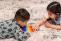 Two cute kids playing with flexible toy the Pop It fidget. Royalty Free Stock Photo