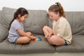 Two cute kids playing with flexible toy the Pop It fidget. Royalty Free Stock Photo