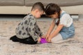 Two cute kids playing with flexible toy the Pop It fidget. Royalty Free Stock Photo