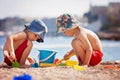 Two cute kids, playing in the sand on the beach