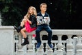 Two cute kids are sitting on the railing. Marble-stone fountain. Royalty Free Stock Photo