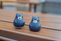 Two cute Kumamon figurines placed on a bench