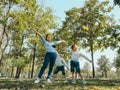 Two cute little Asian girls in summer outfits, having fun with a beautiful young mother smiling happily in the park. Motherhood Royalty Free Stock Photo