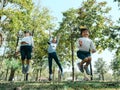 Two cute little Asian girls in summer outfits, having fun with a beautiful young mother smiling happily in the park. Motherhood Royalty Free Stock Photo