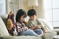 two cute little asian kids using digital tablet at home Royalty Free Stock Photo