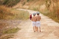 Two cute little boys,brothers, holding a bundle, eating bread an