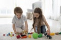 Two cute little brother and sister kids playing with toys Royalty Free Stock Photo