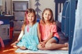 Two cute little Caucasian girls siblings sitting on floor at home room. Happy smiling friends relationship concept. Adorable Royalty Free Stock Photo