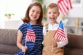 Two cute kids brother and sister with USA flags celebrating Independence day of United States at home Royalty Free Stock Photo
