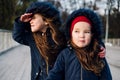 Two cute little children hugging in autumn park. Close up lifestyle fashion portrait of two beautiful caucasian girls outdoors, we Royalty Free Stock Photo