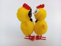 Two cute little easter chicks wearing glasses standing close beak to beak about to kiss on a white background Royalty Free Stock Photo