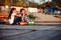 Two cute little friends, boy and girl talking, drinking tea, eating sandwiches and fishing on a lake in a sunny summer day Royalty Free Stock Photo