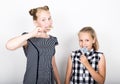 Two cute little girlfriend eating bright lollipops. Funny kids. Best friends pamper and posing