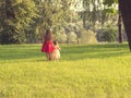 Two cute little girls in beautiful dresses having fun at sunset. Toned Royalty Free Stock Photo