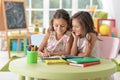 Two cute little girls drawing with pencils Royalty Free Stock Photo