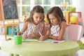 Two cute little girls drawing with pencils Royalty Free Stock Photo