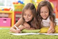 Two cute little girls drawing with pencils Royalty Free Stock Photo