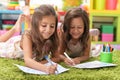 Two cute little girls drawing with pencils Royalty Free Stock Photo