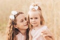 Two cute little girls in dresses hugging in nature in the summer Royalty Free Stock Photo