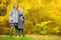 Two cute little girls having fun on beautiful autumn day. Happy children playing in autumn park. Kids gathering yellow fall foliag Royalty Free Stock Photo