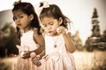 Two cute little girls having fun blowing bubbles in the park Royalty Free Stock Photo