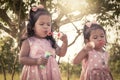 Two cute little girls having fun blowing bubbles in the park Royalty Free Stock Photo