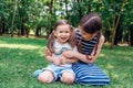 Two cute little girls having fun in park in sunny summer day Royalty Free Stock Photo