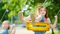 Two cute little girls having fun on a playground outdoors on summer day Royalty Free Stock Photo