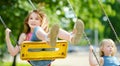 Two cute little girls having fun on a playground outdoors on summer day Royalty Free Stock Photo