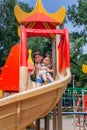 Two cute little girls having fun on a playground outdoors in summer Royalty Free Stock Photo